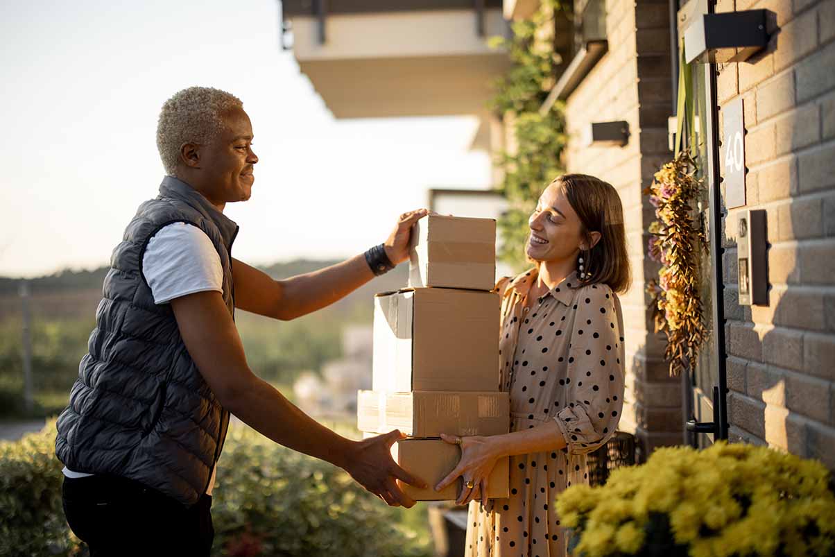 delivery-man-giving-parcels-to-caucasian-woman-2022-01-19-00-01-02-utcLow