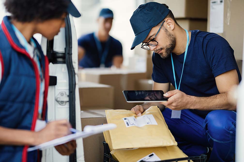 two-workers-preparing-packages-for-delivery-and-sc-2024-12-13-20-27-56-utcLow